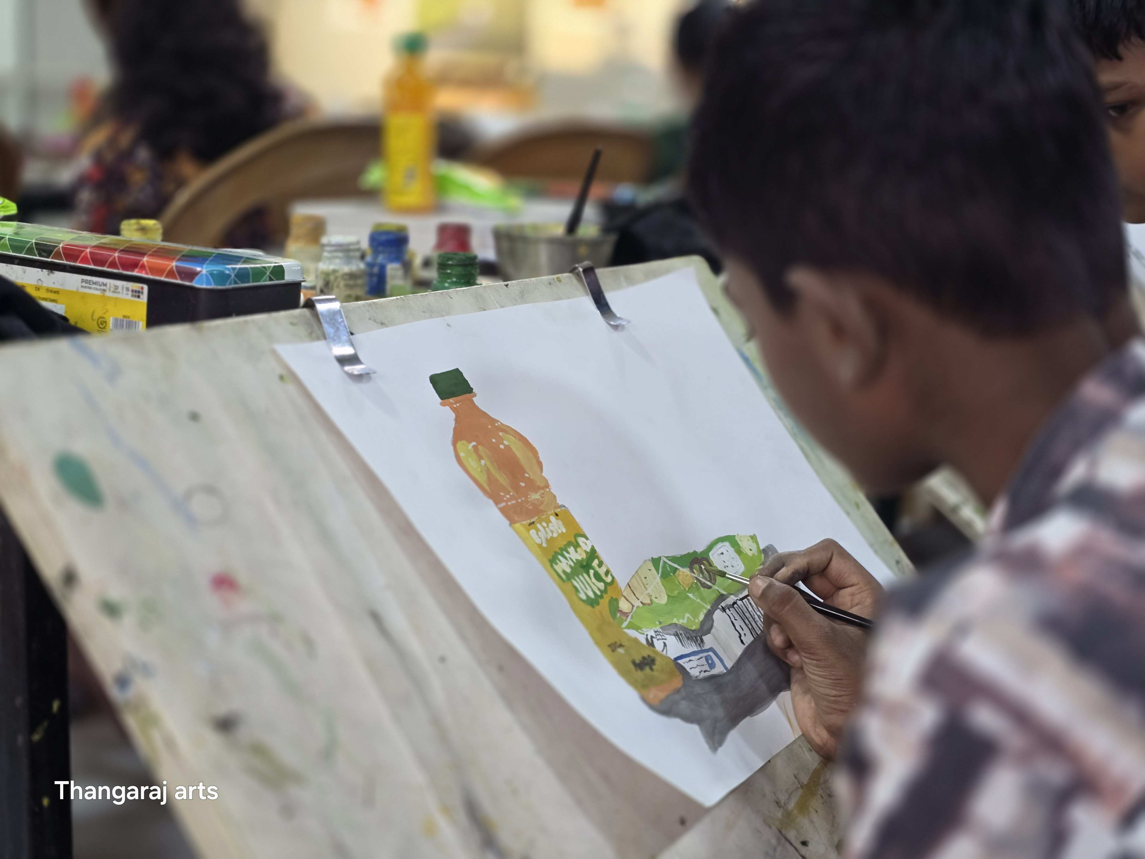 Young student painting in classical art studio